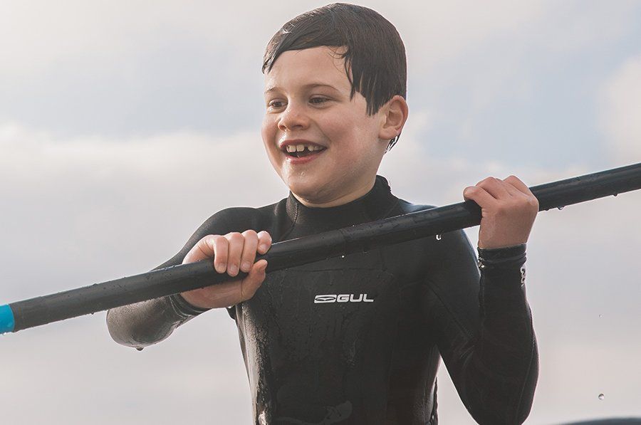 boys in gul wetsuit on sup, click for junior