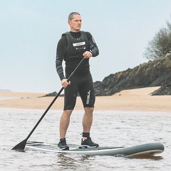 man on sup wearing gul thermal layer, click for thermal layers